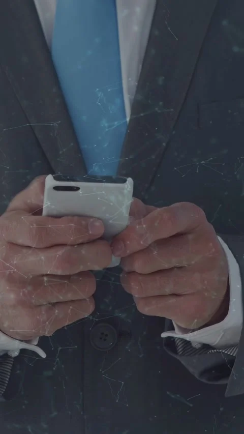 Vertical video: Suit torso holding white phone after brief pause making thumb Stock Footage 333954106