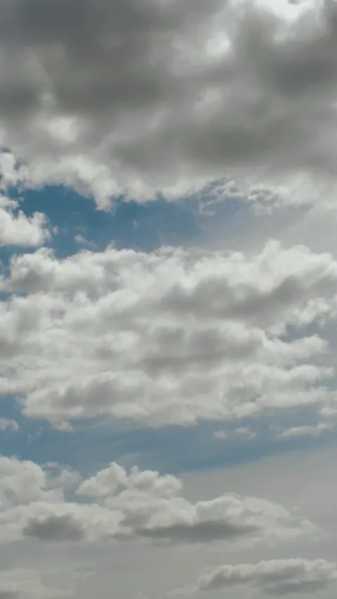 Vertical video. Sun behind the clouds. Dramatic and beautiful blue cloudy sky Stock-Footage 311457265