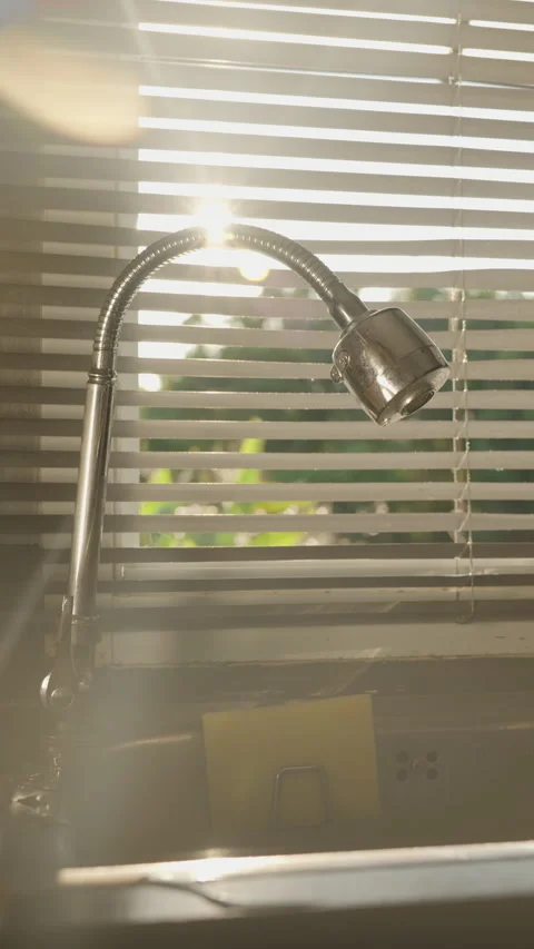 Vertical video. Sun Rays Peeking Through the Gaps of Closed Window Blinds Above Stock Footage 308453627
