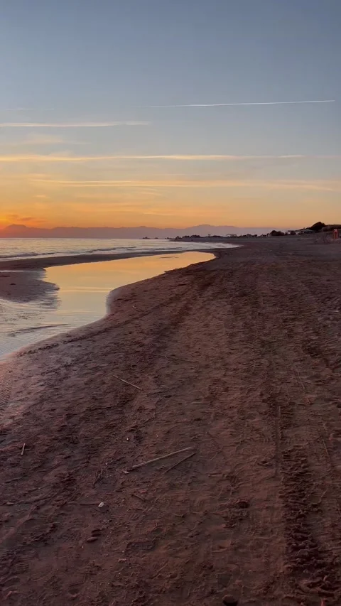 Vertical video, sunset on a deserted beach by the sea Stock Footage 231963824