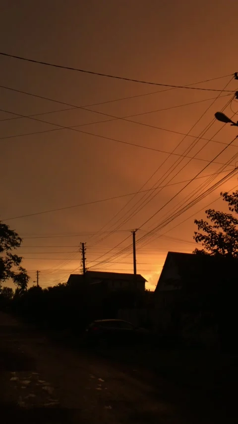 Vertical video, sunset orange sky silhouettes of houses Stock Footage 159140217