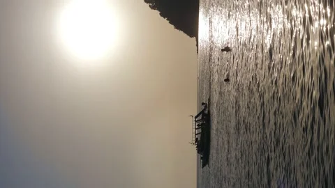 Vertical video. Sunset over the sea with a passing ship. Beautiful seascape Stock Footage 219943950