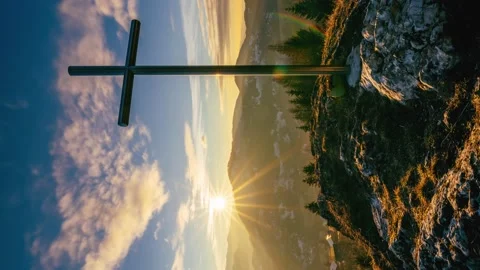 Vertical video of Sunset over steel cross in rocky hill in spring rural nature Stock Footage 229257595