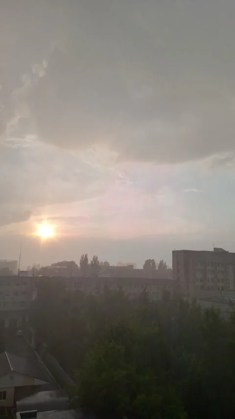 Vertical Video of Sunset with Rain Rare Weather Phenomenon in Cityscape Stock Footage 317250723