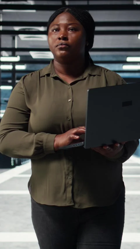 Vertical video Supervisor in data center using laptop to deploy new server Stock Footage 316862819