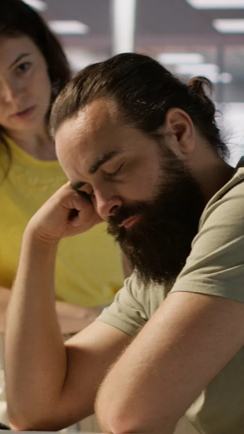 Vertical video Supervisor waking up tired sleeping employee at desk Video stock 319482980