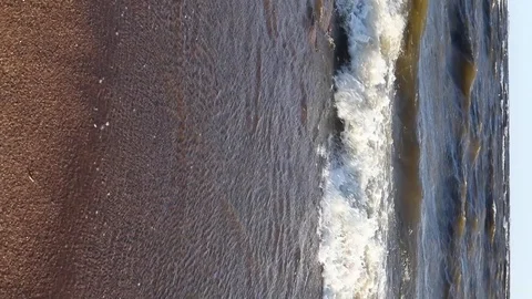 Vertical Video Of Surf On The Coast, Bathed In The Evening Sun. Waves Wash Th Stock-Footage 111418414