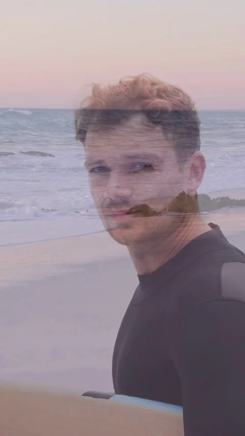 Vertical video: Surfer walking by sea on camera cue, turning, smiling as logo Stock Footage 333721184