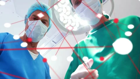 Vertical video: Surgeon operating reaching for clamp, scrub passing tools over Stock Footage 333873046