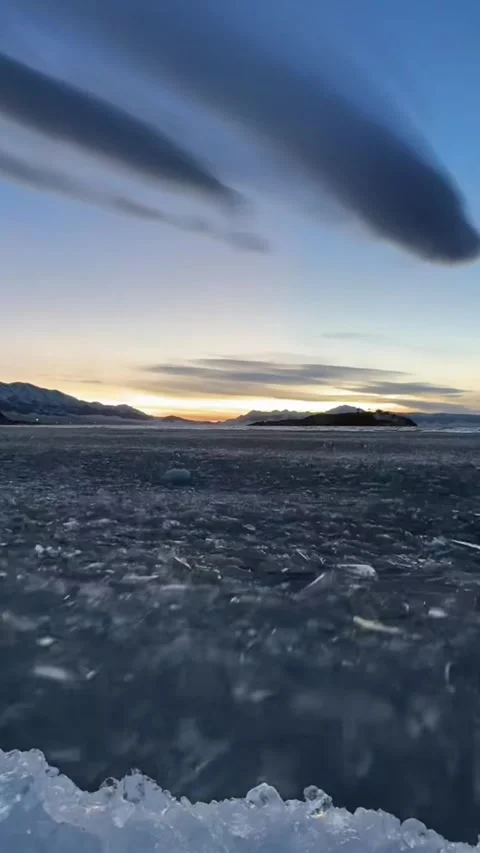 Vertical Video of Surging Blue Ice Shards under Colorful Sunset Clouds in Xi Stock Footage 328389525