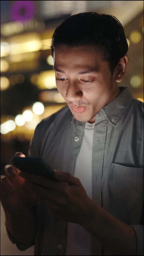 Vertical Video. Surprised Man Reading Through News On Phone. Young Guy Stunned Stock Footage 276382038
