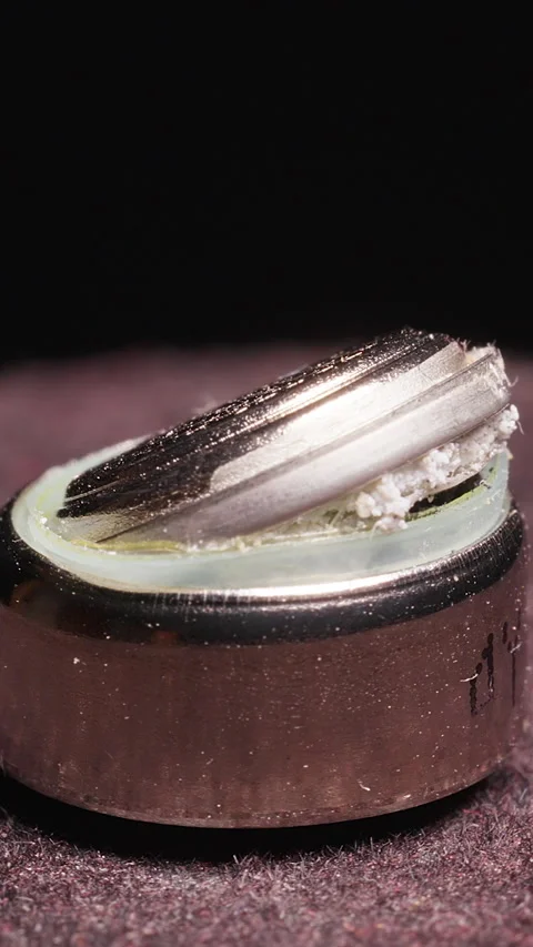 Vertical video. Swollen Exploded Battery with Broken Metal Cap in Macro Loop Rot Video stock 324561377