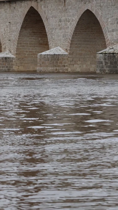 Vertical Video of Swollen River Flowing Under Stone Bridge After Heavy Rain Stock Footage 328220250