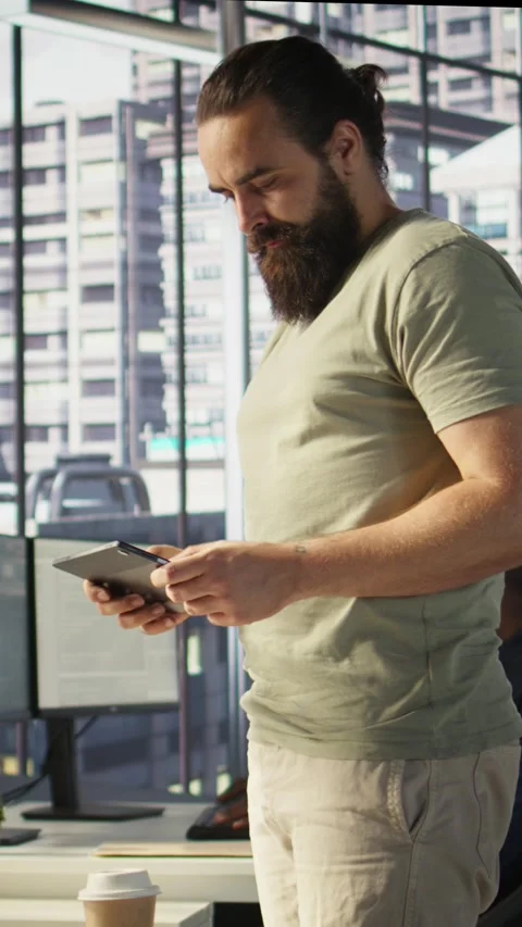 Vertical video System administrator checking machine learning results on tablet Stock Footage 319478684