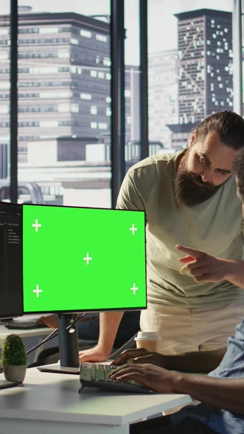 Vertical video System administrator does software debugging on green screen PC Stock Footage 319490270