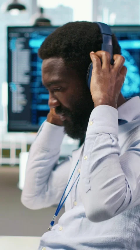 Vertical video System administrator at office desk develops software using AI Stock Footage 312708067