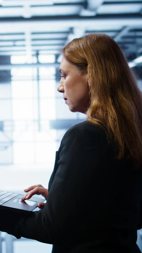 Vertical video System administrator in server farm using laptop to patch network Video stock 277858124