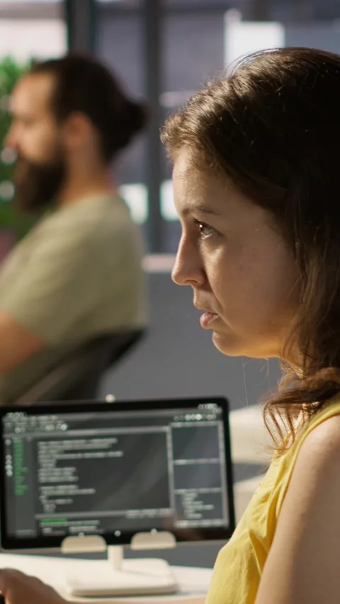 Vertical video System administrator at work doing debugging of AI software using Stock Footage 319486406