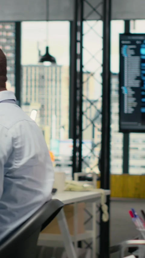 Vertical video System administrators in office automate workflows using Stock Footage 323142440
