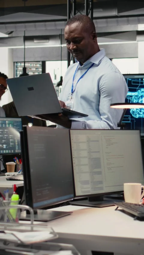 Vertical video System administrators working in AI startup training predictive Stock Footage 323404166