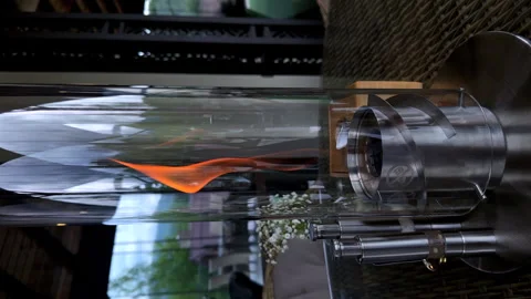 Vertical video on the table there is modern gas candle in a glass flask, the Stock Footage 312447725