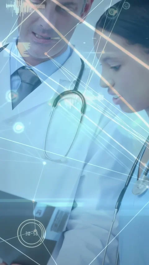 Vertical video: Tablet entering frame, MDs leaning, checking data with blue HUD, Stock Footage 331334127