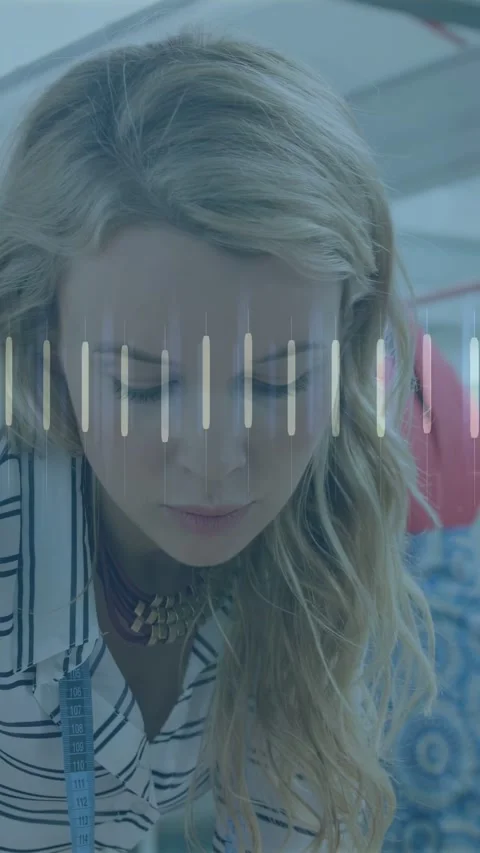 Vertical video: Tailor leaning, checking garment, causing overlay bars, orange Stock Footage 333260102