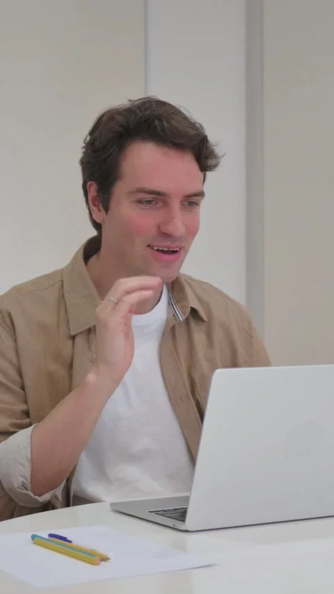 Vertical Video, Talking Young Creative Man Doing Video Chat on Laptop Video stock 318044672