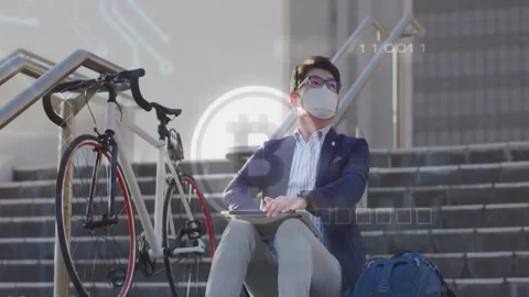 Vertical video: Tapping tablet, man in blazer on steps, HUD rising, checking Stock Footage 331380112