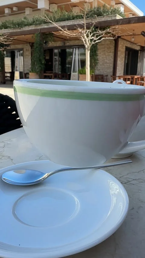 Vertical video. Tea drinking, dining outside. Person taking cup with green tea Видео 331298833