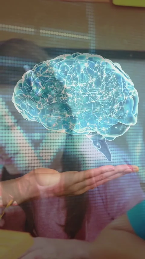 Vertical video: Teacher holding 3D brain above class as boy writing, revealing Stock Footage 328398431