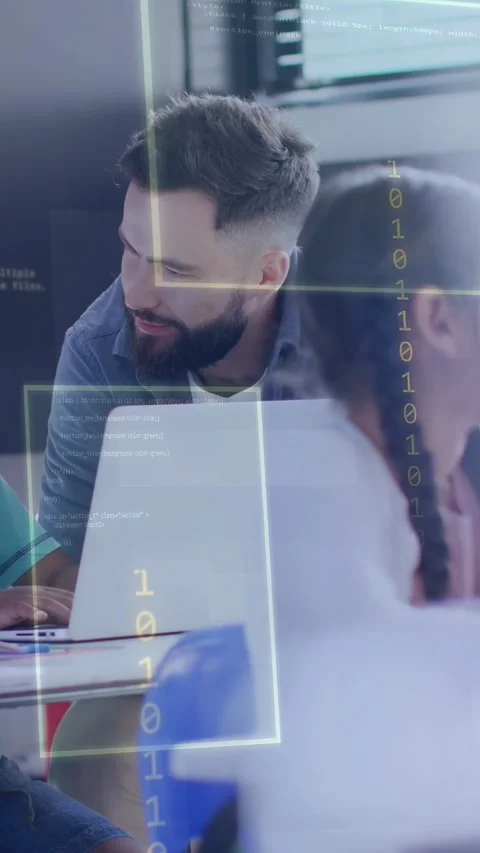 Vertical video: Teacher leaning over laptop as student typing, guiding coding Stock Footage 334378451