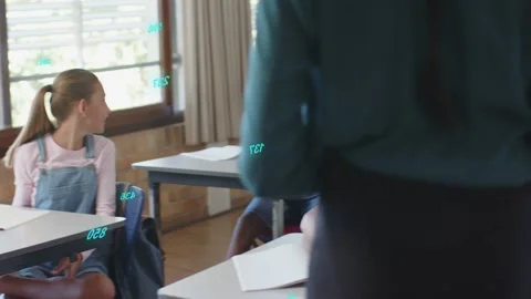 Vertical video: Teacher walking classroom asking question, class raising hands Video stock 333019394