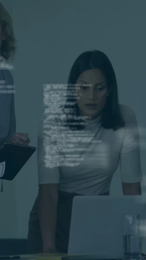 Vertical video: Team lead leaning in at laptop sparking team reviewing tech Stock Footage 334792680