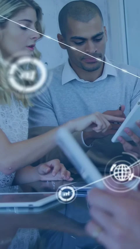 Vertical video: Team leaning over tablet, woman reaching and starting data Stock Footage 334543844