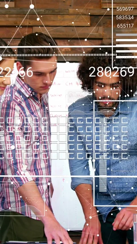 Vertical video: Team leaning at table, center male pointing and using data grid Stock Footage 334599146