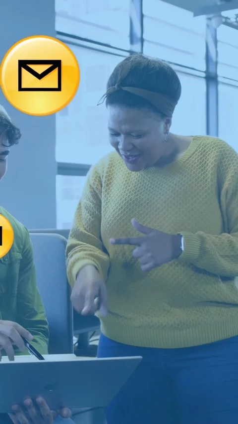 Vertical video: Team pointing at laptop in office, checking emails as mail icons Stock Footage 334770551