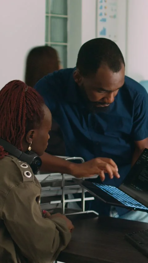 Vertical video: Team of programmers analyzing coding algorithms on laptop and Stock Footage 218577289