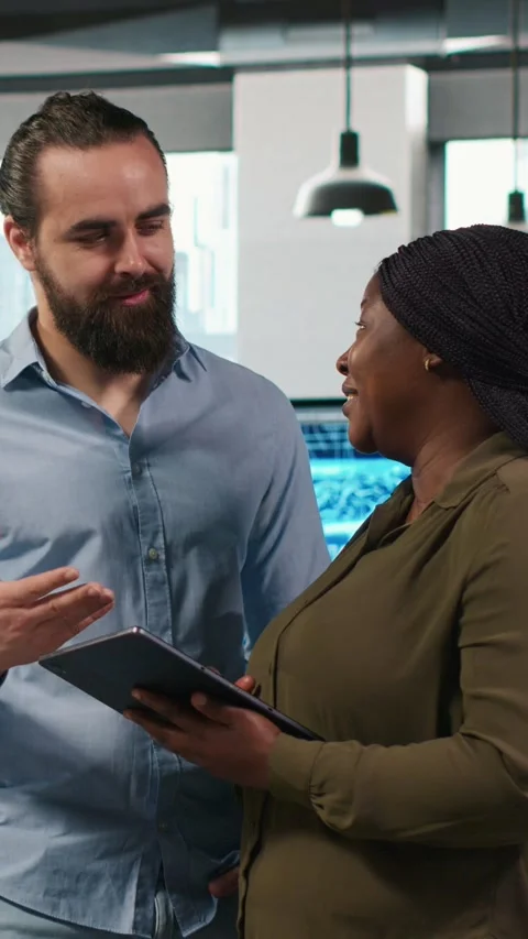 Vertical video Team of programmers in office automating repetitive tasks using Stock-Footage 312708084