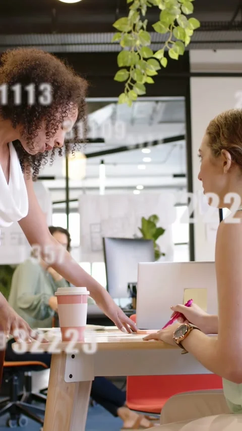 Vertical video: Team reaching and marking docs with pink pen in office, data Stock Footage 334770523