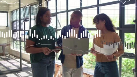 Vertical video: Team reviewing tech data, left pointing at laptop and pages Stock Footage 333019275