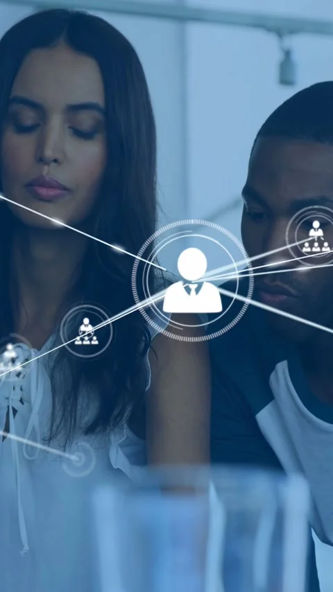 Vertical video: Team reviewing tech data, circular icon appearing, growing Stock Footage 333895688