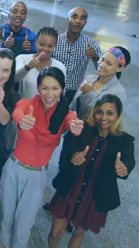 Vertical video: Team seeing camera, joining and giving thumbs-up under dotted Stock Footage 332277863