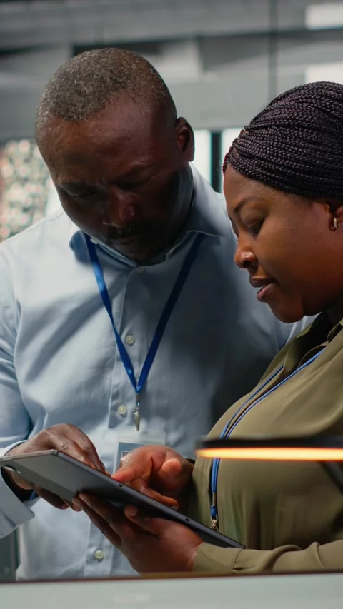 Vertical video Team of software developers in office automating workflows using Stock Footage 322696567