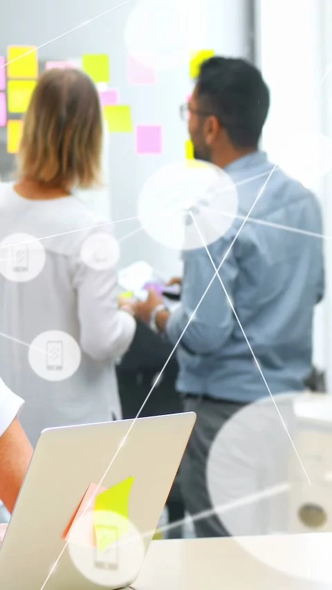 Vertical video: Team tapping pad, moving notes on wall for business, wifi icons Stock Footage 333006236