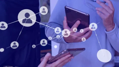 Vertical video: Team tapping phones and tablet sparking network nodes linking Stock Footage 334114382