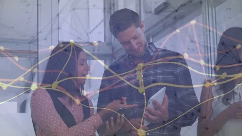 Vertical video: Team tapping tablet reviewing biz data as network nodes flowing Stock Footage 333132173
