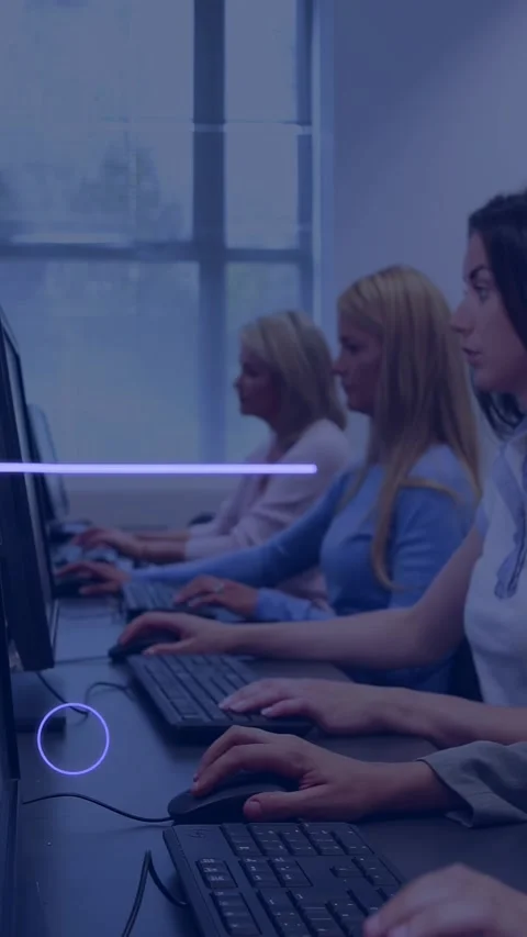 Vertical video: Team typing at desks by window, neon eye appearing, sweeping Stock Footage 329840320