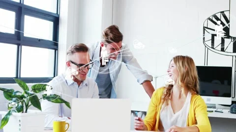 Vertical video: Team working at desk, laptop tap showing network icons while Stockbeeldmateriaal 332275686