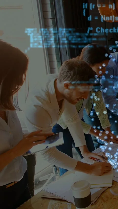 Vertical video: Team working at table, left woman nudging tablet causing code Stock Footage 333303608